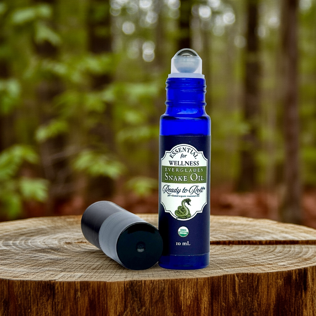Everglades Snake Oil Organic Essential Oil by Ready to Roll® in the woods on a tree stump