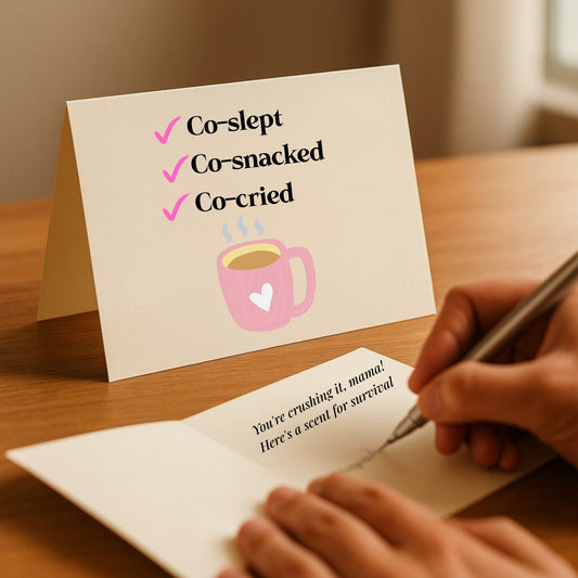 Humorous Co-Slept, Co-Cried card for essential oil gift sets, featuring a checklist and pink coffee cup and handwritten message from Essential for Wellness.
