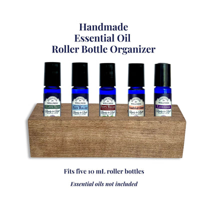 Handmade essential oil roller bottle organizer with five bottles on a white background